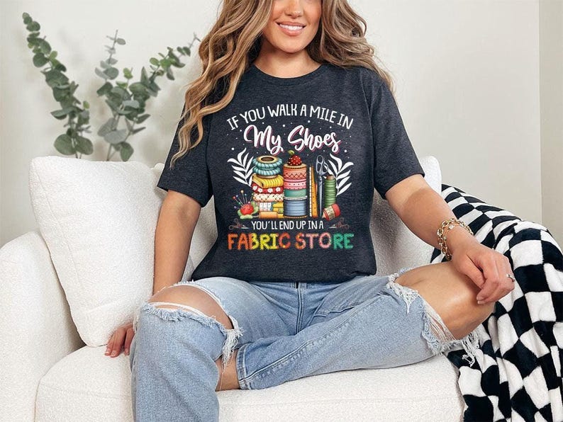 a woman sitting on a couch wearing a black shirt