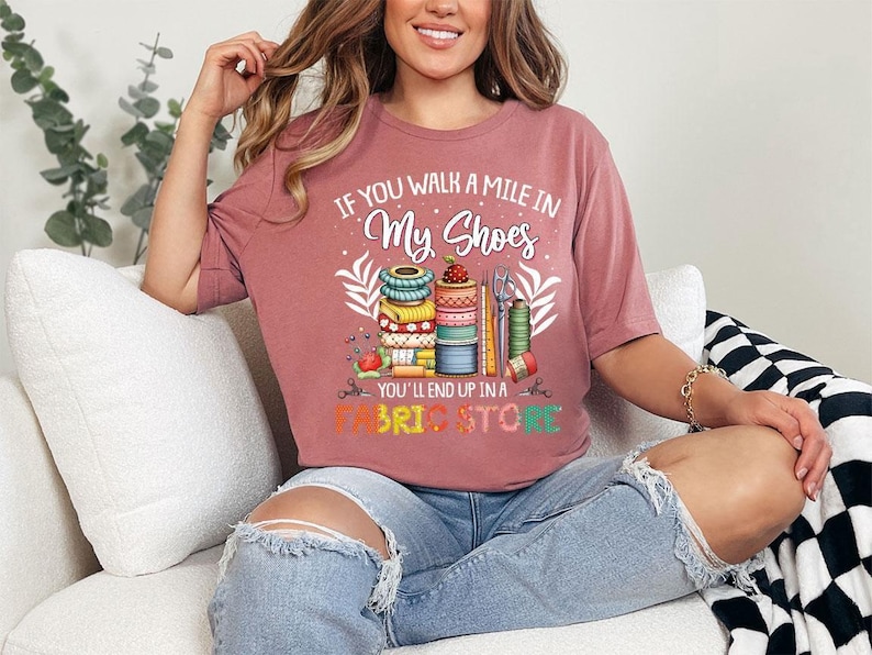 a woman sitting on a couch wearing a pink shirt