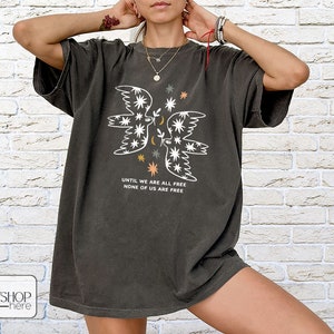 a woman wearing a t - shirt with an image of a butterfly on it