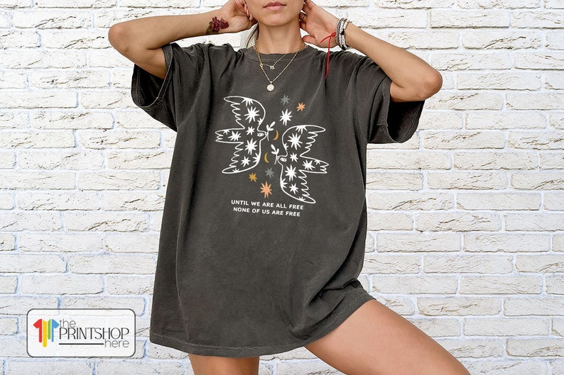 a woman wearing a t - shirt with an image of a butterfly on it