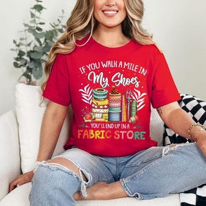 a woman sitting on a couch wearing a red shirt