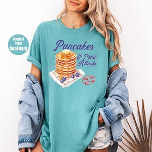 a woman wearing a pancake and toast t - shirt