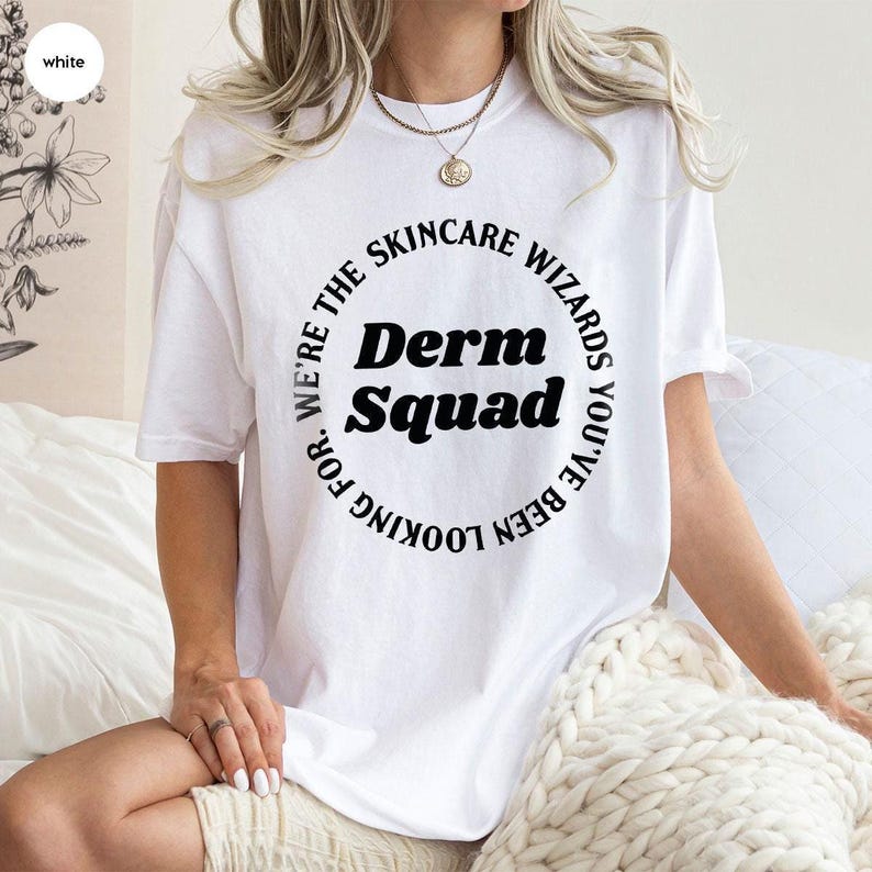 a woman sitting on a bed wearing a white shirt