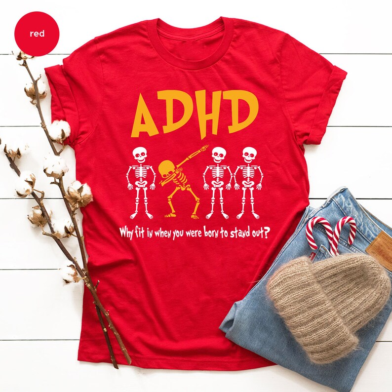 a red shirt with a skeleton and candy canes on it