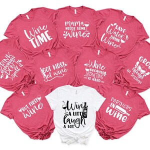 a bunch of shirts that are on a white surface