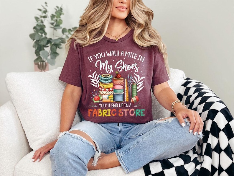 a woman sitting on a couch wearing a t - shirt