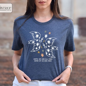 a woman wearing a t - shirt with an angel on it