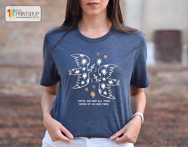 a woman wearing a t - shirt with an angel on it