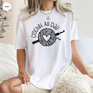 a blue t - shirt with a crochet all day on it