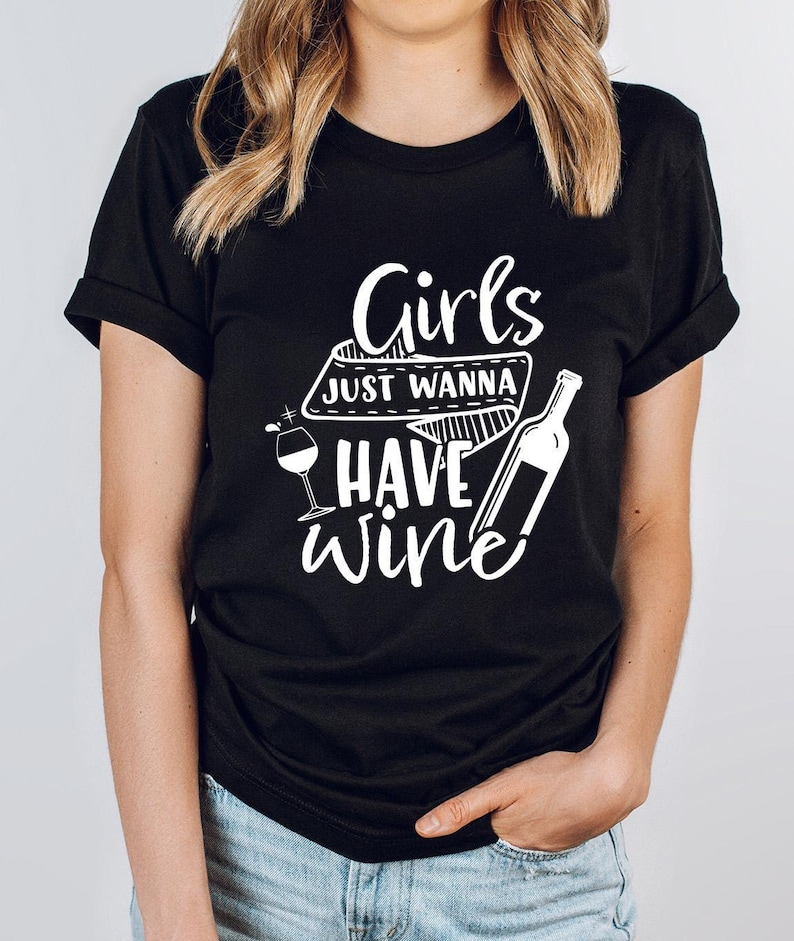 a woman wearing a t - shirt that says girls just wanna to have wine
