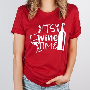 a woman wearing a red tshirt that says its wine time