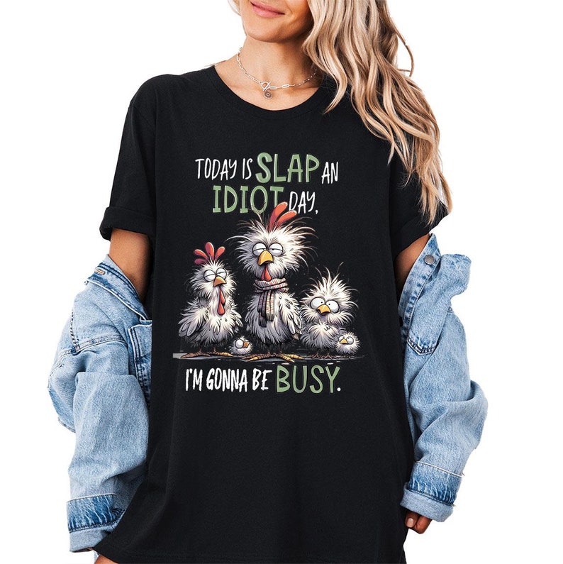 a woman wearing a black t - shirt that says today is slap an idiot day