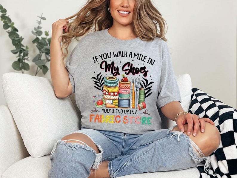 a woman sitting on a couch wearing a t - shirt