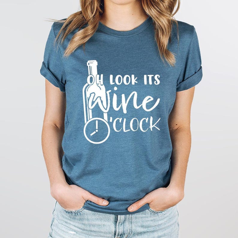 a woman wearing a t - shirt that says, look it's wine clock