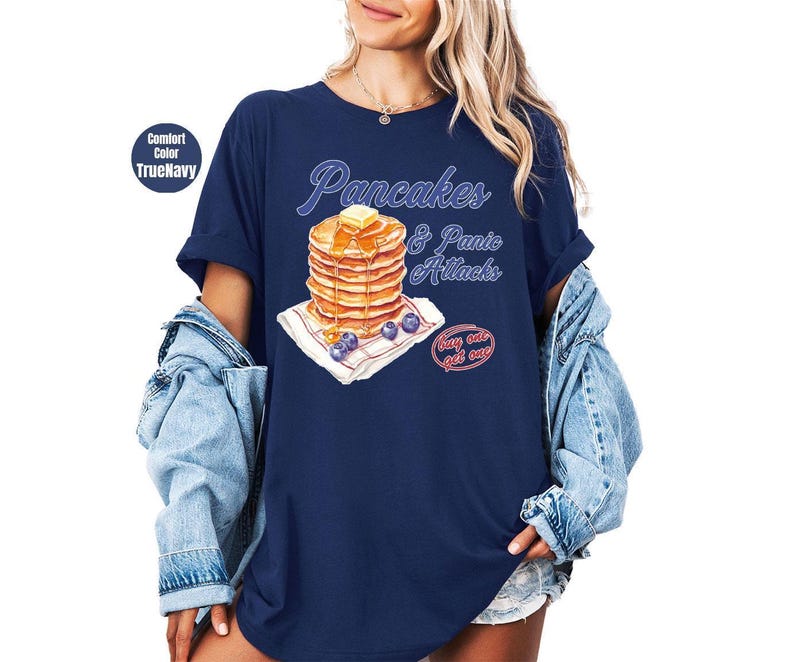 a woman wearing a blue shirt with pancakes on it