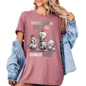 a woman wearing a t - shirt that says, today is slap an idiot day