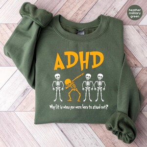 a green sweatshirt with a skeleton design on it