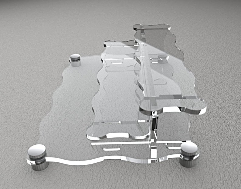 Pode incluir: Um suporte de vidro transparente de dois n&iacute;veis com uma borda ondulada. O suporte tem quatro p&eacute;s de metal prateado.
