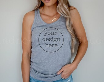 May include: A gray tank top with a black circle on the front that says "your design here".