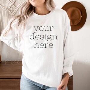 May include: White long-sleeve sweatshirt with the text "your design here" printed on the front.