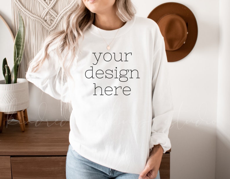 May include: White long-sleeve sweatshirt with the text "your design here" printed on the front.