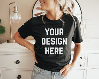 May include: A black t-shirt with the text "YOUR DESIGN HERE" printed in white on the front.