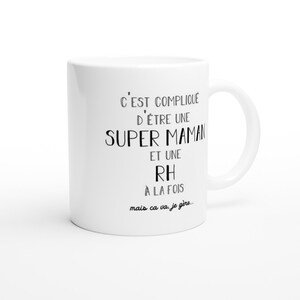 May include: White ceramic mug with black text that reads "C'EST COMPLIQU&Eacute; D'&Ecirc;TRE UNE SUPER MAMAN ET UNE RH &Agrave; LA FOIS mais ca va, je g&egrave;re..."