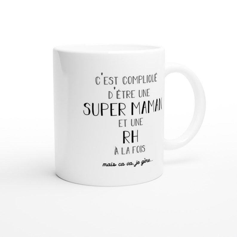 May include: White ceramic mug with black text that reads "C'EST COMPLIQU&Eacute; D'&Ecirc;TRE UNE SUPER MAMAN ET UNE RH &Agrave; LA FOIS mais ca va, je g&egrave;re..."