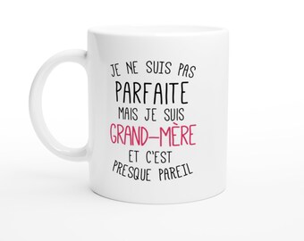 May include: White ceramic mug with black text that reads "Je ne suis pas parfaite mais je suis grand-mère et c'est presque pareil". The word "grand-mère" is in pink.