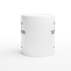 May include: White ceramic coffee mug with black text that reads "It's  easier to be a  superhero  when you're  already  a  badass  man".