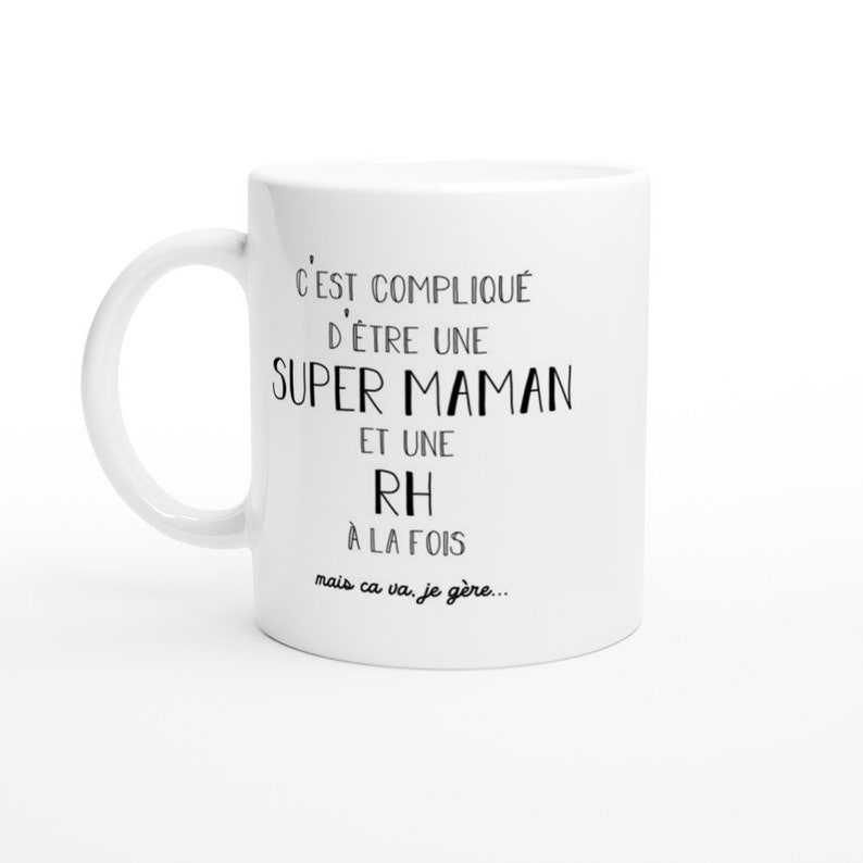 May include: White ceramic mug with black text that reads "C'EST COMPLIQU&Eacute; D'&Ecirc;TRE UNE SUPER MAMAN ET UNE RH &Agrave; LA FOIS mais ca va. je g&egrave;re..."