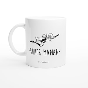 May include: White ceramic mug with a black line drawing of a woman flying with a cape and the text "SUPER MAMAN" and the text "quotedezur" at the bottom.