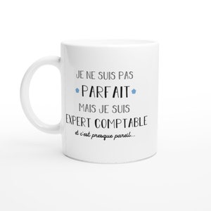 May include: White ceramic mug with black text that reads "Je ne suis pas parfait mais je suis expert comptable et c'est presque pareil..."