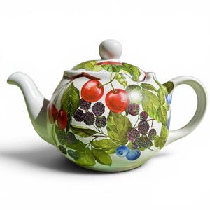 May include: A white ceramic teapot featuring a colorful botanical illustration of red cherries, dark blackberries, and blue blueberries with green leaves. The teapot has a curved spout, a rounded handle, and a matching lid with a small knob handle.