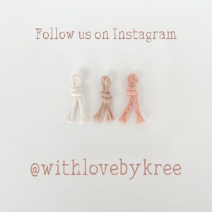 Op de afbeelding: Drie geknoopte macram&eacute;-koorden in off-white, bruin en perziktinten worden getoond op een witte achtergrond. De tekst "Follow us on Instagram" en "@withlovebykree" zijn gedrukt in een zachte bruine kleur.
