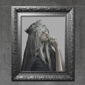 May include: A framed portrait of a woman with long, white hair wearing a crown and a veil. The woman is looking down and has her hand on her chin. The frame is ornate and silver.