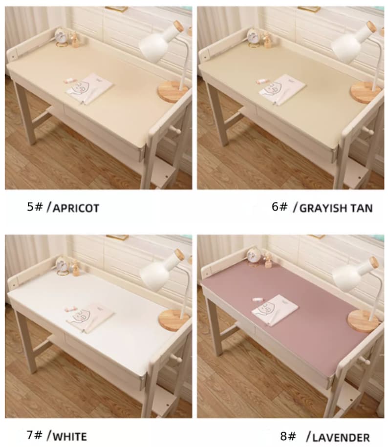 May include: Four different colored desk mats on a wooden desk. The mats are in the colors apricot, grayish tan, white, and lavender. Each mat is on a desk with a lamp and a book on it.