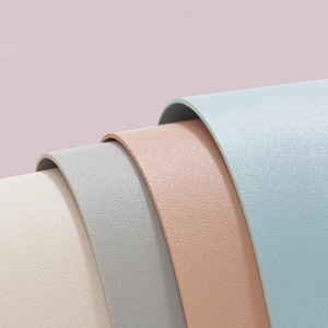 May include: Four rolls of textured vinyl in different colors: white, light gray, light pink, and light blue.