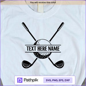 May include: White t-shirt featuring a black golf-themed design. The design includes crossed golf clubs, a golf ball, and the text "TEXT HERE NAME" in a horizontal banner. The shirt also has the text "You will receive this color".