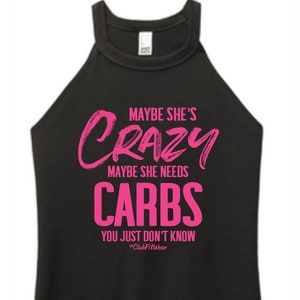 May include: Black tank top with a pink graphic that says "Maybe she's crazy maybe she needs carbs you just don't know #ClubFitwear"