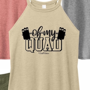 May include: A beige tank top with a black graphic that says "oh-my QUAD" with a barbell and weights on either side of the text. The text "#ClubFitwear" is below the graphic.