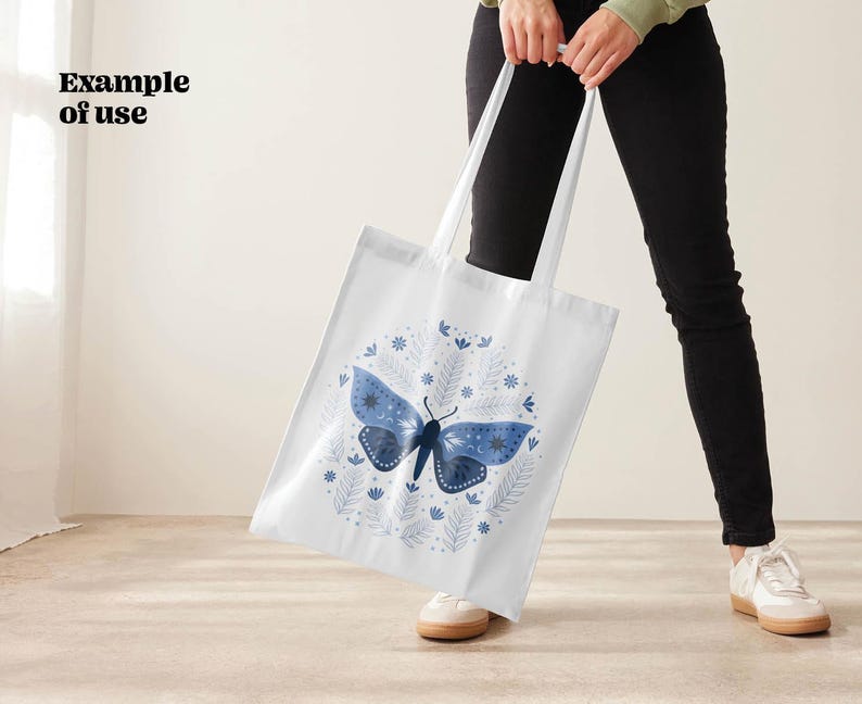 White tote bag with a blue moth and floral design. The moth has a dark blue body and light blue wings. The floral design is in shades of blue and white.