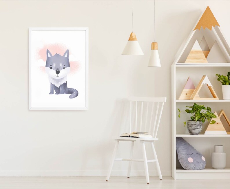 May include: A white framed print of a cartoon wolf with a pink and white background. The wolf is sitting down and looking at the viewer. The print is hanging on a white wall.