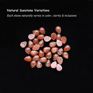 May include: A collection of pear-shaped sunstones in shades of orange and reddish-brown with sparkling inclusions. Text reads: Natural Sunstone Variations. Each stone naturally varies in color, clarity & inclusions.