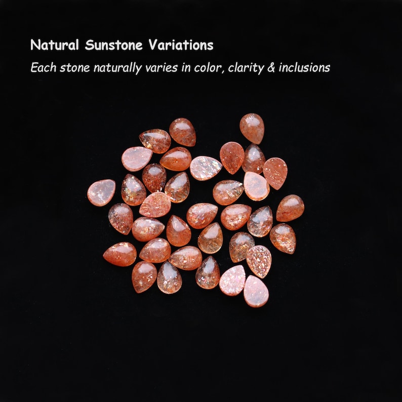 May include: A collection of pear-shaped sunstones in shades of orange and reddish-brown with sparkling inclusions. Text reads: Natural Sunstone Variations. Each stone naturally varies in color, clarity & inclusions.