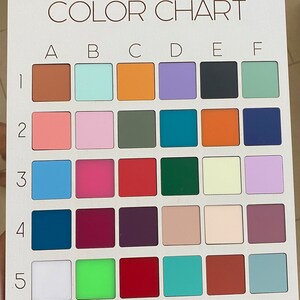 May include: A white rectangular color chart featuring a grid of thirty square color swatches. The grid is labeled with letters A through F across the top and numbers 1 through 5 down the side. Each square displays a distinct solid color.
