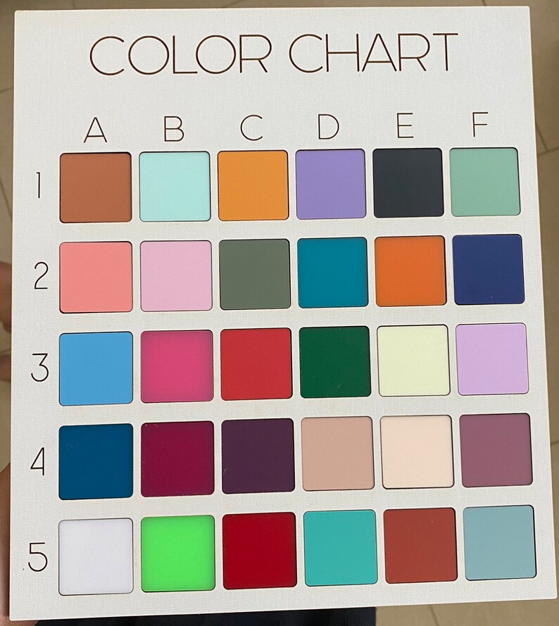 May include: A white rectangular color chart featuring a grid of thirty square color swatches. The grid is labeled with letters A through F across the top and numbers 1 through 5 down the side. Each square displays a distinct solid color.