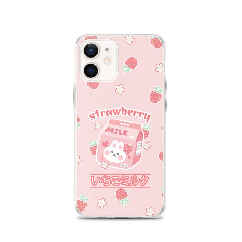 May include: A pink phone case with a cartoon bunny on a carton of strawberry milk. The case has a white border and a repeating pattern of strawberries and flowers. The text "strawberry milk" and "いちごミルク" is printed on the case.