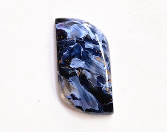 May include: A polished, teardrop-shaped gemstone with a striking pattern of deep blue, white, and gold hues. The stone's surface is smooth and glossy, showcasing a unique, swirling design. The gemstone is set against a white background.