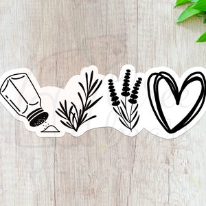 May include: Black and white sticker design with a salt shaker, rosemary sprig, lavender sprig, and a heart. The design is on a light wood background.